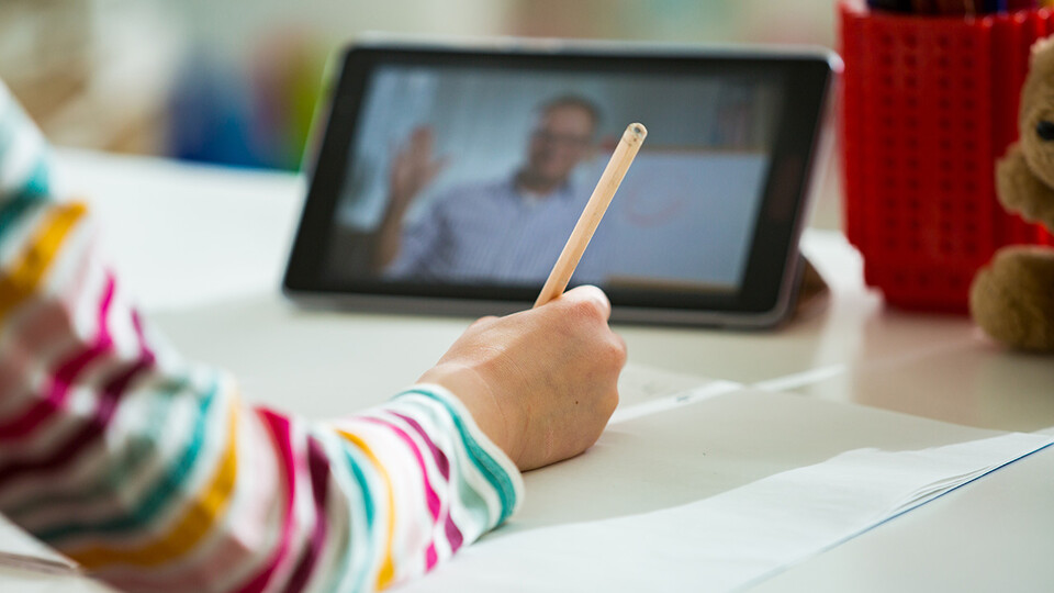student with IPad and pen