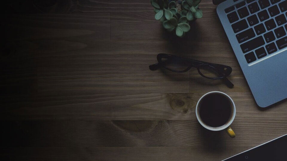coffee cup and laptop on desk