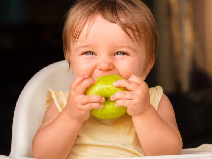 Child eating green apple