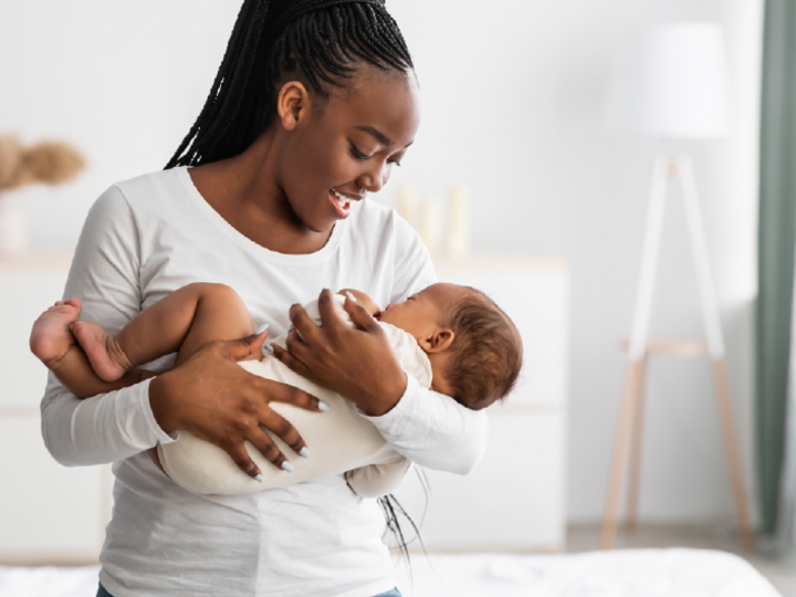 Woman singing to a child in her arms