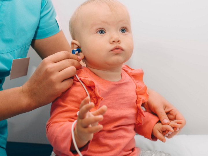 Baby heaving ears tested by a medical staff person