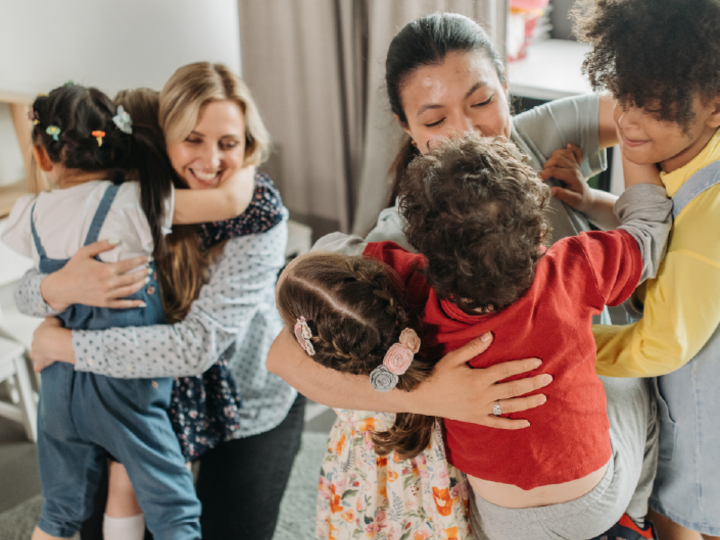 Childcare providers getting hugs from the preschool children