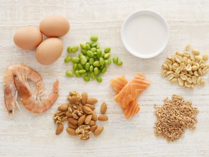 Eggs, shrimp, almonds, peas, salmon and other food allergens on table