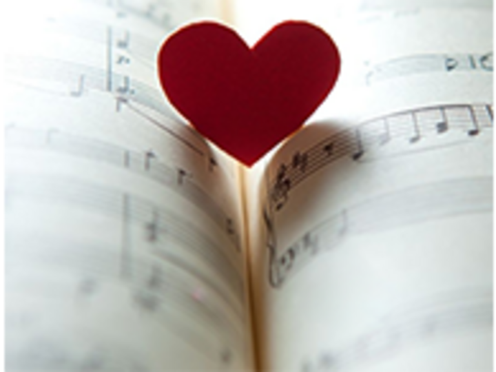Sheet music with red paper heart standing up in the crease