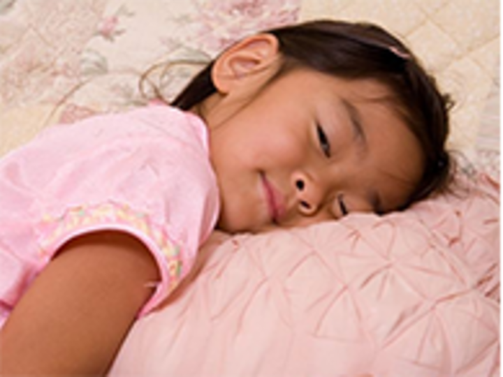 Young child laying head on a pillow