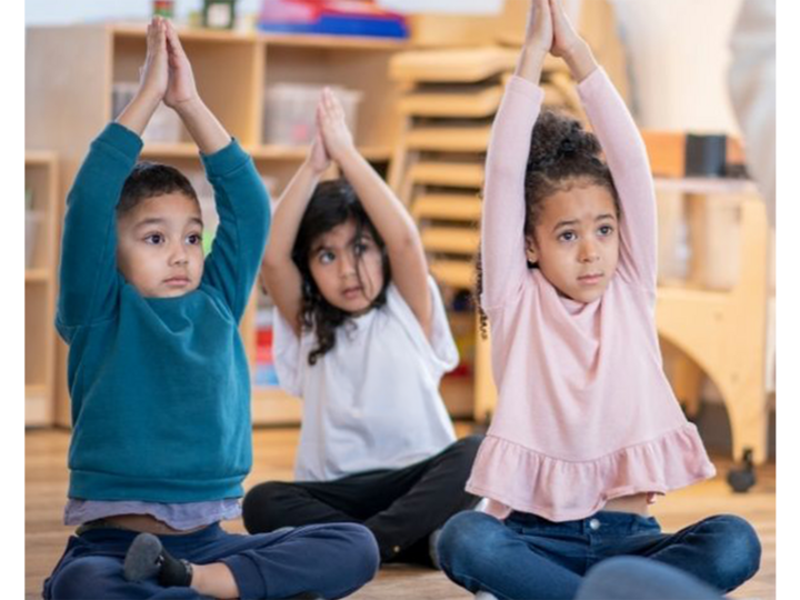 Three children doing yoga together